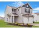 Charming two-story home with gray siding, white garage door, and landscaped front yard at 604 Rhino Bnd, Oxford, NC 27565