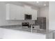 Contemporary kitchen with white shaker cabinets, stainless steel appliances, and a granite countertop at 604 Rhino Bnd, Oxford, NC 27565
