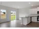 Open kitchen with white cabinetry, a granite-topped island, and stainless steel appliances at 604 Rhino Bnd, Oxford, NC 27565