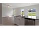 Bright open kitchen and living space with wood-look floors, white cabinets, and granite countertops at 604 Rhino Bnd, Oxford, NC 27565