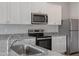 Modern kitchen featuring white shaker cabinets, stainless steel appliances, and granite countertops at 604 Rhino Bnd, Oxford, NC 27565