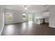 Spacious living area with wood-look flooring, ceiling fan, and sliding glass doors leading to the backyard at 604 Rhino Bnd, Oxford, NC 27565