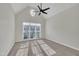 Bright bedroom with vaulted ceiling, large window, and ceiling fan at 105 Michael Way, Clayton, NC 27520