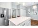 Island kitchen with white cabinets and stainless steel appliances at 109 Parkerson Ln, Apex, NC 27502