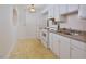 Efficient kitchen with white cabinets and appliances at 130 S Estes Dr # G5, Chapel Hill, NC 27514