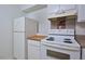 White appliances and wood countertops in kitchen at 130 S Estes Dr # G5, Chapel Hill, NC 27514