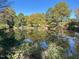 Serene lake reflecting autumn foliage and trees at 130 S Estes Dr # G5, Chapel Hill, NC 27514