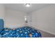 Spacious bedroom with blue upholstered bed and access to another room at 1598 Wareham Dr, Mebane, NC 27302