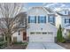 Two-story home with beige siding, red door, and two-car garage at 226 Begen St, Morrisville, NC 27560