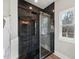 Modern shower with dark tile, glass enclosure, and built-in shelving at 2418 Crossroads Ave, Hillsborough, NC 27278