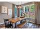 Bright dining area with a wooden table, bench, and window views at 269 Ivy Ridge Rd, Chapel Hill, NC 27516