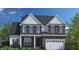 Two-story home with brick and shingle siding, a white front door, and a two-car garage at 269 Ivy Ridge Rd, Chapel Hill, NC 27516