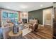 Living room with fireplace, access to screened porch and wood flooring at 269 Ivy Ridge Rd, Chapel Hill, NC 27516