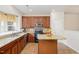 Kitchen with granite countertops, wooden cabinets, and island at 2765 Wyntercrest Ln, Durham, NC 27713