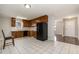 Kitchen features wood cabinets, tile floors, and a black refrigerator at 28 Park Place Street St, Angier, NC 27501