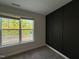 Bedroom with window, neutral carpet and dark accent wall at 2823 Dallas Valley Ln, Apex, NC 27502