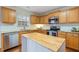 Kitchen boasts granite counters, stainless steel appliances, and island at 3069 Buttonwood Ln, Clayton, NC 27520