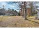 Large backyard with mature trees and grassy area at 312 Burkwood Ln, Raleigh, NC 27609