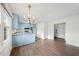 Kitchen features light blue cabinetry and stainless steel appliances at 312 Burkwood Ln, Raleigh, NC 27609