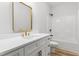 Modern bathroom with white vanity, gold fixtures, and a shower/tub combo at 4017 Mebane Oaks Rd, Mebane, NC 27302