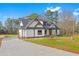 New farmhouse style home with white siding and gray roof at 4017 Mebane Oaks Rd, Mebane, NC 27302