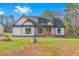 Craftsman style home with white siding, gray roof, and a charming front porch at 4017 Mebane Oaks Rd, Mebane, NC 27302