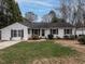 Charming ranch home with white siding, landscaping, and a spacious yard at 505 Harvard St, Raleigh, NC 27609