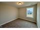 Bright bedroom with carpeted floors and large window at 523 Eversden Dr, Zebulon, NC 27597