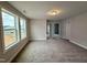 Bright bedroom with neutral carpeting and two large windows at 523 Eversden Dr, Zebulon, NC 27597