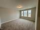 Spacious bedroom with neutral carpeting and a window with a view at 523 Eversden Dr, Zebulon, NC 27597