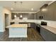 Modern kitchen with gray cabinets, granite countertops, and stainless steel appliances at 523 Eversden Dr, Zebulon, NC 27597