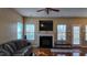 Spacious living room with hardwood floors, fireplace, and lots of natural light at 528 Summer Storm Dr, Durham, NC 27704