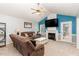 Living room with brown couches, a fireplace, and access to a deck at 62 Clarence Ln, Garner, NC 27529