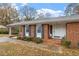 Brick ranch house with covered porch and landscaping at 6400 Malibu Dr, Raleigh, NC 27603