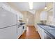 Bright kitchen with white cabinets and hardwood floors at 8300 Hempshire Place # 104, Raleigh, NC 27613