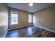 Bright bedroom with hardwood floors and two windows at 919 Blue Garden Ln, Willow Springs, NC 27592