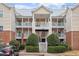 Three-story building with light beige siding, balconies, and a staircase at 524 Glenolden Ct, Cary, NC 27513