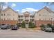 Beige multi-unit building with brick accents, ample parking, and landscaping at 524 Glenolden Ct, Cary, NC 27513