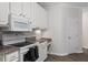 White kitchen cabinets, granite countertops, and electric range at 524 Glenolden Ct, Cary, NC 27513