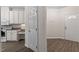 White kitchen cabinets, granite countertops, and a view of the entryway at 524 Glenolden Ct, Cary, NC 27513
