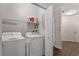 Bright laundry room with washer, dryer, and shelving at 524 Glenolden Ct, Cary, NC 27513