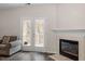 Living room featuring fireplace and balcony access at 524 Glenolden Ct, Cary, NC 27513