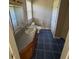 Bathroom with single vanity, toilet, and tile flooring at 6101 Valentine St, Zebulon, NC 27597