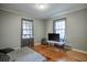 Simple bedroom with hardwood floors and gray walls at 810 Brooklyn St, Raleigh, NC 27605