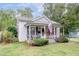 Quaint 1-story house featuring a front porch and lush landscaping at 810 Brooklyn St, Raleigh, NC 27605