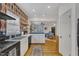 Bright kitchen boasts white cabinets, open concept to living area, and hardwood floors at 810 Brooklyn St, Raleigh, NC 27605
