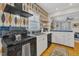 Stylish kitchen with white cabinets, blue tile backsplash, and black appliances at 810 Brooklyn St, Raleigh, NC 27605