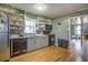 Charming kitchen with gray cabinets and wood floors at 810 Brooklyn St, Raleigh, NC 27605