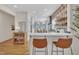Modern kitchen with white cabinets, breakfast bar, and patterned backsplash at 810 Brooklyn St, Raleigh, NC 27605