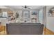 Open living room with hardwood floors, gray sectional sofa, and a TV at 810 Brooklyn St, Raleigh, NC 27605